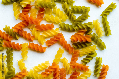 Multicolor spiral pasta on the white background