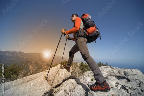 Man hiking in the mountains on a sunny day.