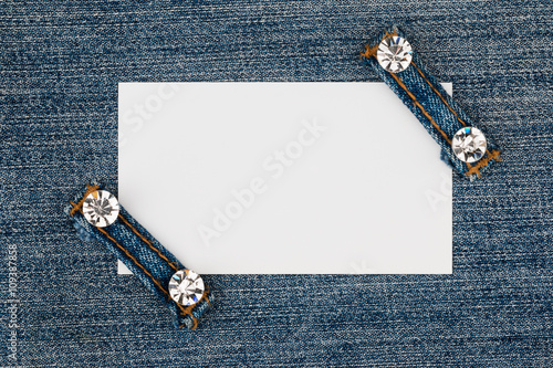 Business card with two straps jeans, lies on the light denim