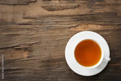 Cup of tea on wooden background, top view