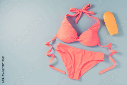 Pink swimsuit on blue background