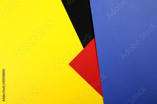 Color papers geometry flat composition background with yellow red blue and black tones