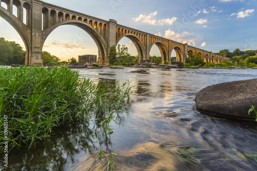 Richmond Railroad Bridge Lit by Sun/ The graceful arches of a railroad bridge spanning the James River in Virginia are illuminated by the setting sun.