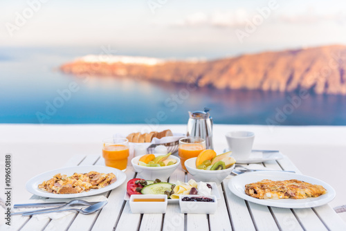 Breakfast table romantic by the sea. Perfect luxury breakfast table for two outdoors. Amazing caldera view on Santorini, Greece, Europe.