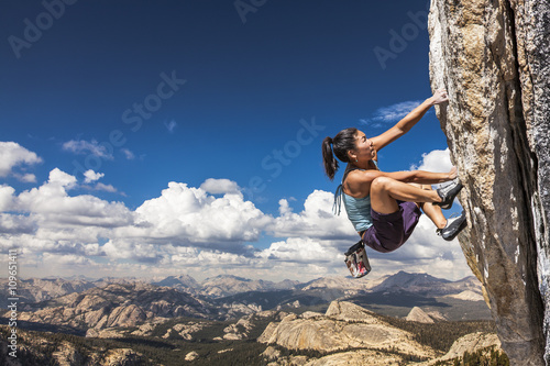 Rock climber clinging to a cliff.