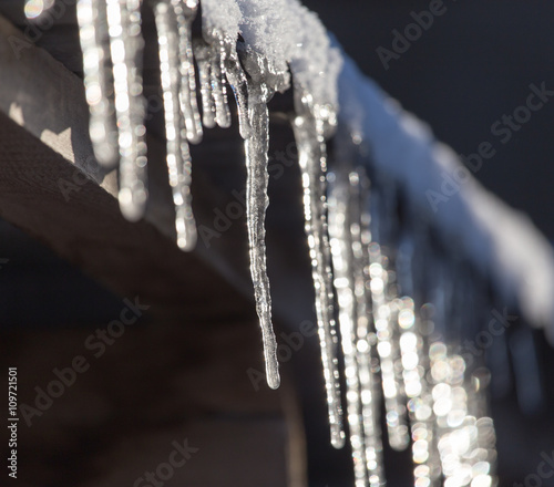 Long and dangerous icicles on a house roof