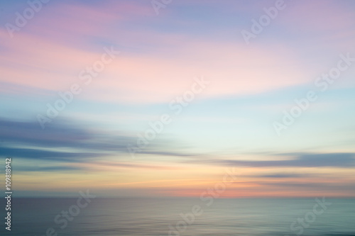 Blurred defocused sunset sky and ocean nature background.