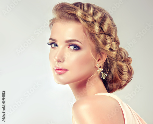 Beautiful model girl with elegant hairstyle . Beautiy woman with fashion wedding hair and colourful makeup 