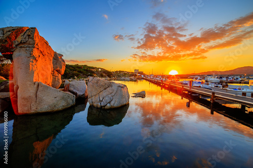 A sunset over lake with a port in the background