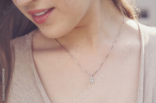 Detal of woman wearing a luxury pendant