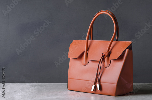 women leather handbag on gray background