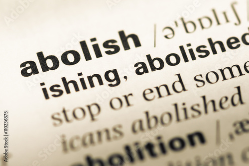 Close up of old English dictionary page with word abolish