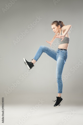 Portrait of woman jumping in studio