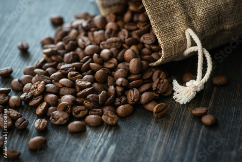 Roasted coffee beans on old wooden table