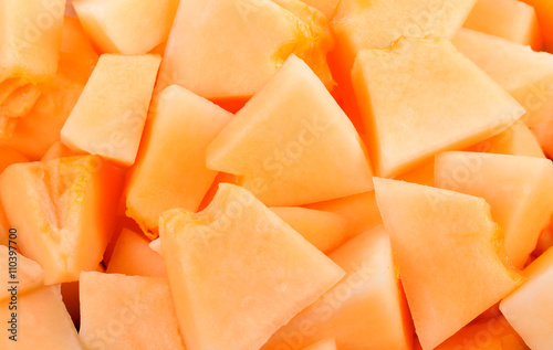 cantaloupe malons slices on white plate on white background