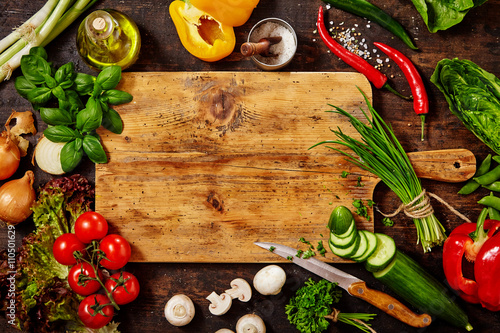 Cutting Board and Knife with Vegetables on Table