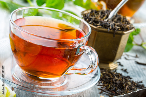 Tea. Mint Tea. Herbal tea. Mint leaf. Mint leaves. Tea in a glass cup, mint leaves, dried tea, sliced lime. herbs tea and mint leaves on a slate plate in a restaurant or teahouse tea room.