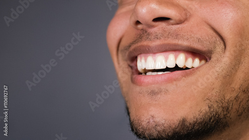 Healthy teeth of a male as he smiles at something, space for text
