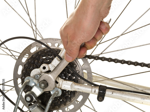 Man repairing rear wheel on a bicycle