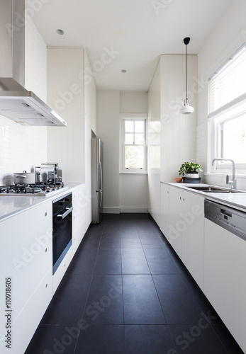 Vertical of a long galley style monochrome kitchen