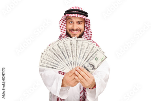 Joyful Arab holding a stack of money