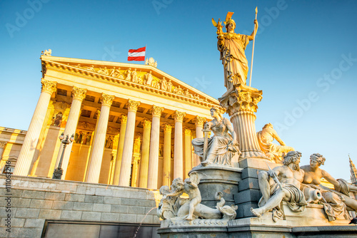 Austrian parliament building with Athena statue on the front in Vienna on the sunrise