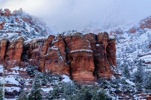 Outcrop of Sedona, Arizona's vivid red sandstone during a winter storm