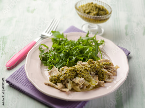 stewed meat with pesto sauce and arugula salad, selective focus
