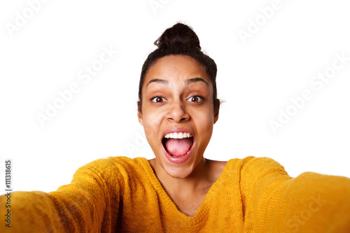 Excited young african lady taking selfie and laughing