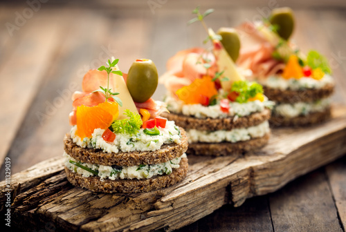 Canapes with prosciutto and cheese 