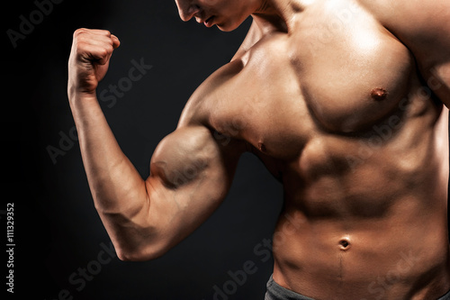 Image of very muscular man posing with naked torso