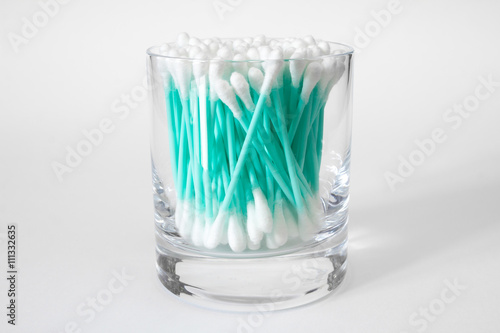 Cotton swabs in clear glass jar isolated on white