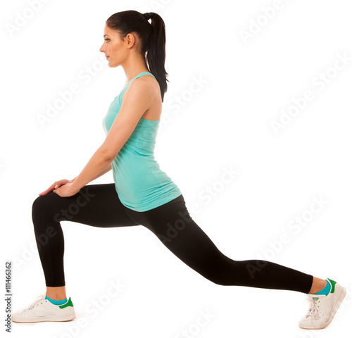 Beautiful young hispanic woman doing lunge exercise in fitness g