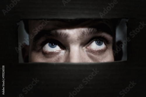 Men spying through a hole