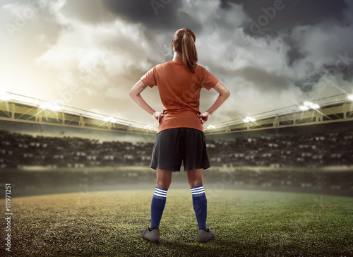 Female football player standing on the field