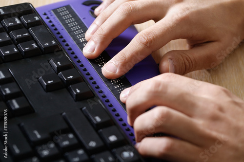 Blind person using computer with braille computer display