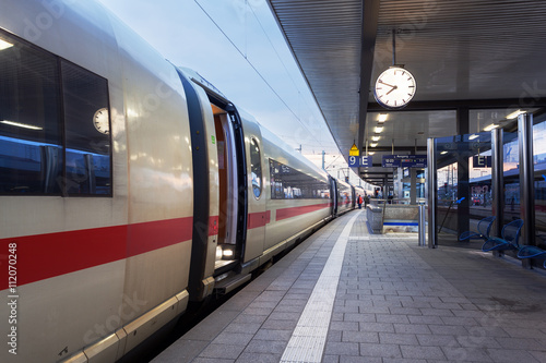 High speed passenger train on railroad platform. Railway station in Nuremberg, Germany.