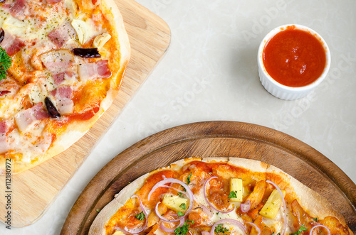 Hawaiian Chicken BBQ Italian Pizza and Bacon,Garlic and Chilli Italian Pizza and tomato sauce on wood dish 