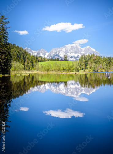 Wilder Kaiser reflecting in mountain lake, Kitzbühel, Tyrol, Austria