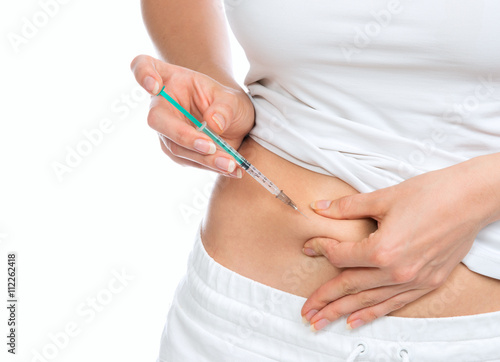 Medical diabetes insulin syringe injection shot into abdomen wit
