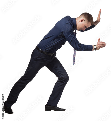 Young Businessman pushing wall, on white