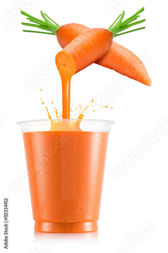 Pure carrot juice pouring out from fruit in plastic cup