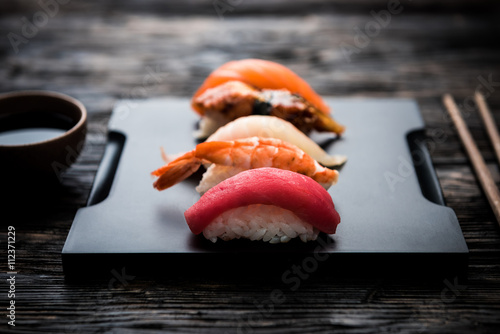 sashimi sushi set with soy on black background