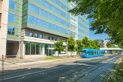 Modern tram on the street in Zagreb, Croatia, new office building in background