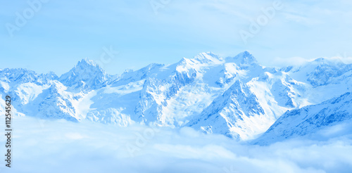 beautiful winter landscape of Caucasus mountains with clouds and