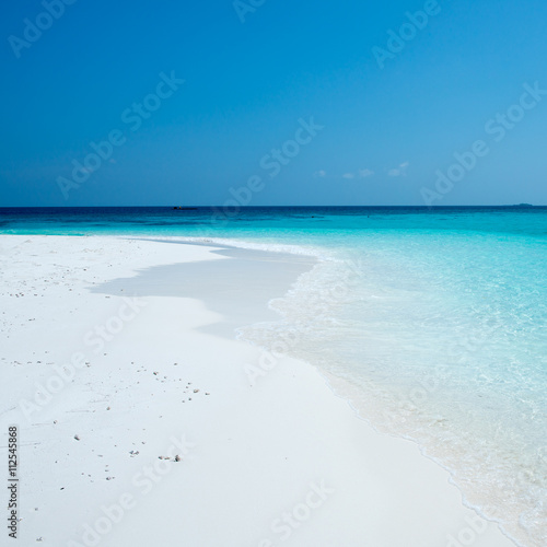 Maldives. Ari Atoll. Waves on the white sand beach
