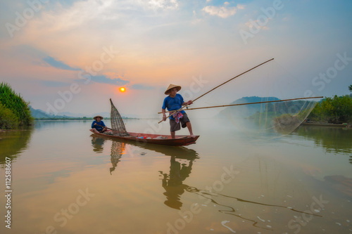 Fishermen in action when fishing in the mekong river , Thailand.