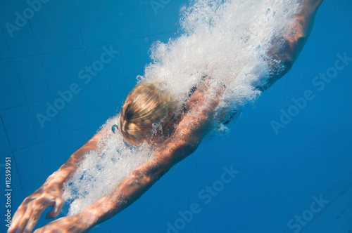 Blonde girl diving, underwater view