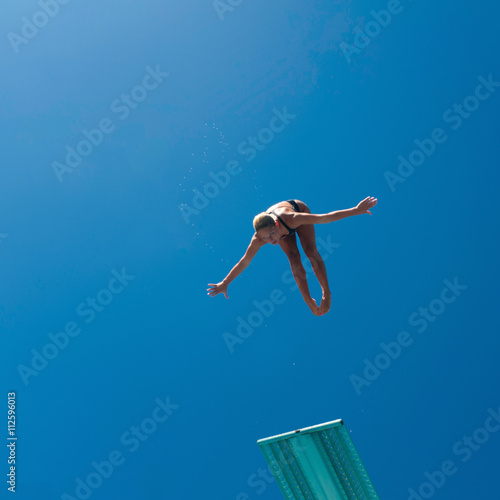 Female springboard diving champion in air