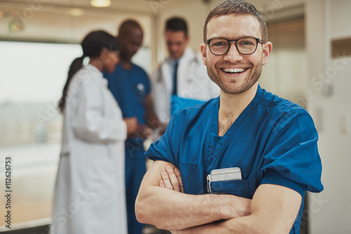 Happy optimistic young hospital surgeon